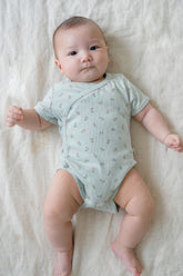 Baby Lying Down in Avauma Clare Mint Rose Short Sleeve Bodysuit, Comfortable and Breathable Summer Outfit